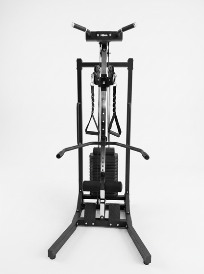 A black multi-functional home gym cable machine with weight stacks and resistance bands, photographed against a seamless white studio background.